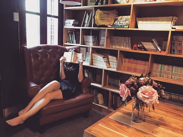 A person comfortably reading in a cozy armchair